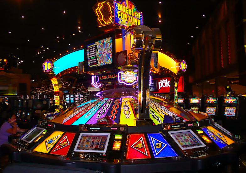 Bright neon Wheel of Fortune machine in a casino. Photo by La super Lili.